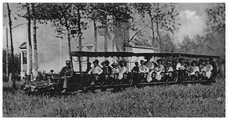 (Image: A Locomotive Pulls Three Coaches of Park Patrons)
